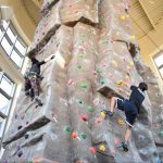 students rock climbing indoors at the Climbing Tower