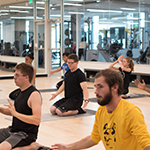 Students taking yoga at the Group Exercise Studio at RWC@Downtown. 